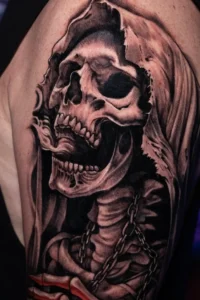 black and grey skull arm tattoo