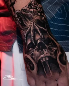 black and grey skull on arm